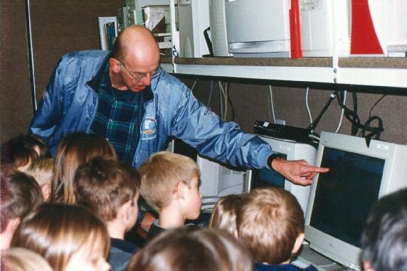 Jeff Keeler (NCAR) with visiting school kids inside S-Pol science trailer.  #2.jpg