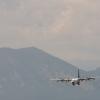 Airplane flying through smoky mountains.