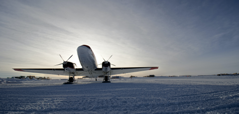 Airplane on snowy runway.